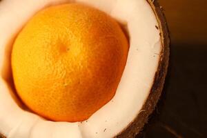 A Fresh Orange Beautifully Displayed Inside a Unique, Split Coconut Shell for a Unique Look photo