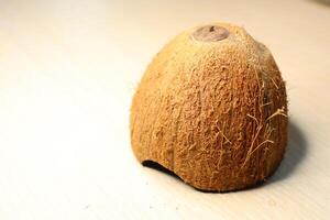 Natural Coconut Shell with Fibers Displayed on a Beautifully Light Surface Background photo