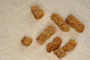 Crunchy croutons on a rustic surface, perfect for enhancing salads and soups at any meal photo