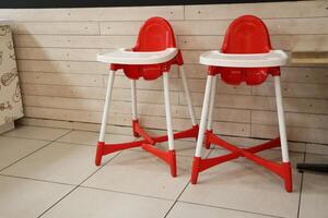 Stylish Bright Red High Chairs Designed Specifically for Kids in a Modern Dining Space photo