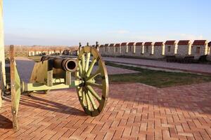 A Historic Cannon is on Display, Set Against a Scenic Outdoor Background and Setting photo