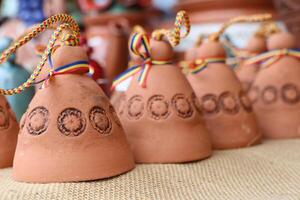 Beautifully Colorful Clay Bells Adorned with Unique Decorative Strings for Festive Decor photo