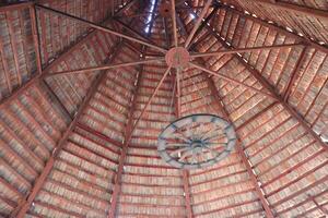 Rustic Wooden Structure Featuring a Unique Layered Roof Design That Exudes Warmth and Charm photo