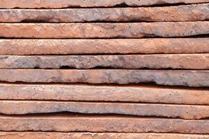 A beautifully textured stack of weathered wooden slabs or planks with unique patterns and colors photo