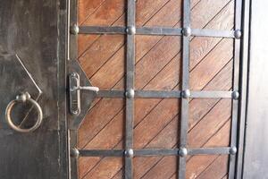 Elegant Wooden Door with intricate Iron Detailing and a Knocker for added appeal photo
