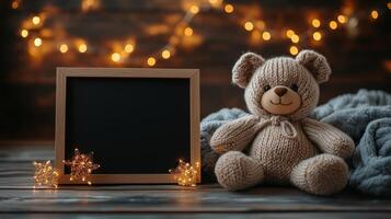 Teddy bear and blank blackboard on wooden background with christmas lights photo