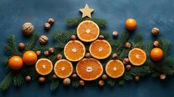 Christmas tree made of oranges and nuts on a blue background photo