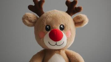 A stuffed reindeer with red nose and antlers photo