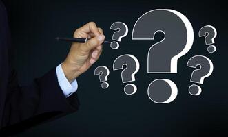 Businessman hands show pen writing question marks, Confused, Thinking, brainstorming or decision making concept, problem solving, finding answers photo