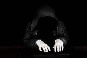 Computer hacker in hoodie, Virus infected software. photo