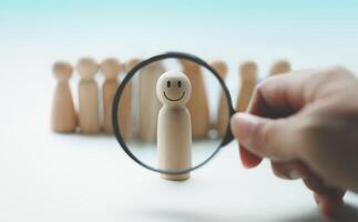 Hand holding a magnifying glass in human resource search, talent management photo