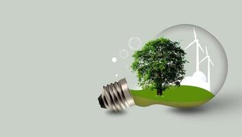 Light bulb with tree and Wind turbines on green background. Energy resources banner photo