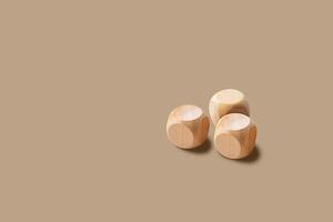 three wooden blocks on a brown surface photo