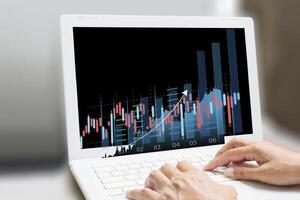 a person is using a laptop with a graph on it photo