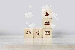 wooden cubes with icons of email, phone and other communication symbols photo