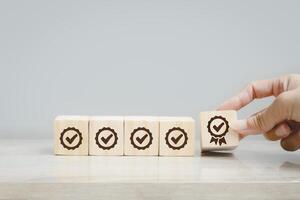 a person is placing wooden blocks with the word check on them photo