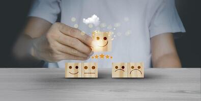 Customer review a person is holding wooden blocks with smiley faces photo