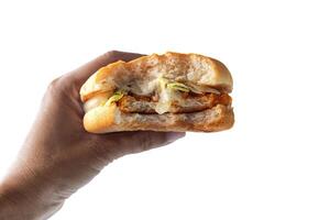 a hand holding a sandwich with cheese and lettuce photo