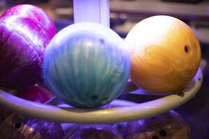 bowling balls are stacked in a rack photo