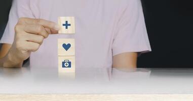 a person holding wooden blocks with icons on them photo