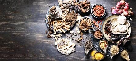 various spices and herbs on a wooden table photo