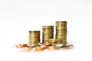 gold coins and stacks of coins on white background photo