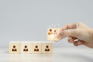hand holding wooden blocks with people on them photo