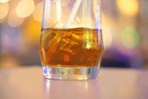 a glass of iced tea with a straw photo