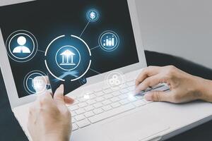a person using a laptop with icons on the screen photo