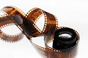 a roll of film with a camera lens on top photo