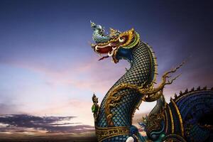 a dragon statue is on top of a hill photo