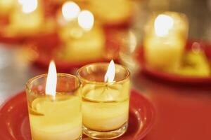 candles on red plates with yellow candles photo