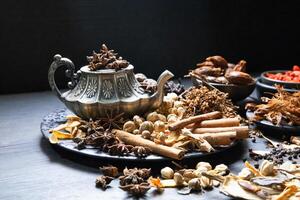 a variety of spices and herbs are arranged on a table photo