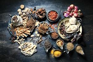 various spices and herbs are arranged on a table photo