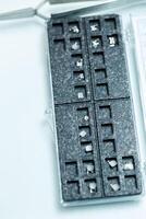 Metal braces for installing the structure on the teeth in the hands of an orthodontist. The orthodontist holds new braces in his hands, prepares it for a patient in a dental clinic, photo