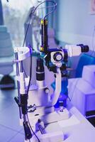 A modern microscope for vision testing in a light room. Microscope for vision correction. photo