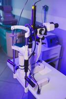 A modern microscope for vision testing in a light room. Microscope for vision correction. photo