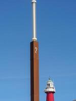 A tall pole with a clock on it photo
