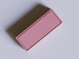 A pink rectangular box sitting on a table photo