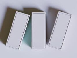 Three empty boxes on a white surface photo