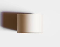 A white cylinder on a white surface photo