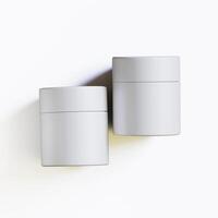 Two white containers with lids on a white surface photo