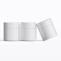 Three white containers with lids on a white surface photo