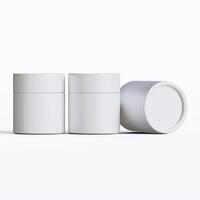 Three white containers with lids on a white surface photo