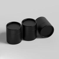 Three black containers with lids on a white surface photo