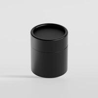 A black container with a lid on a white surface photo