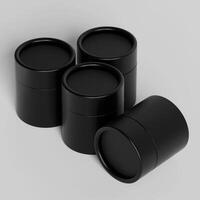 Four black containers with lids on a white surface photo