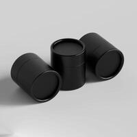 Three black containers with lids on a white surface photo