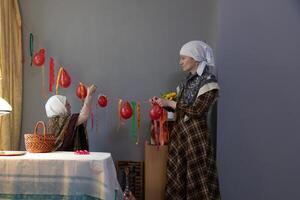 A woman and a child are decorating a table with balloons photo