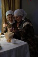 Two women sitting at a table photo